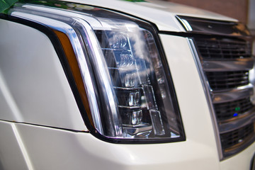 Closeup of new projector headlight on the modern car.