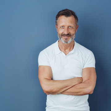 Smiling middle-aged man with arms folded