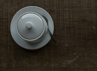 White bowl on wooden background, vintage tone filter