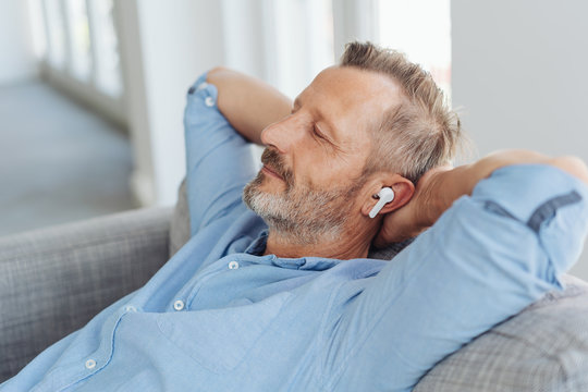 Man Enjoying Music In Wireless Earplugs