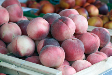 Wooden Box of peaches on the street market