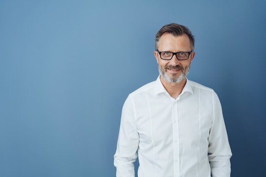Smiling man in glasses and white shirt, copy space