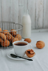 Nuts for tea with condensed milk on a wooden table.