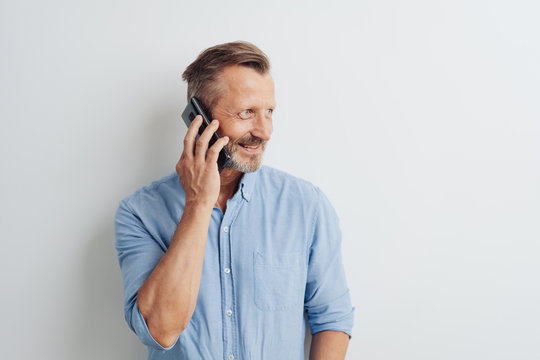 Casual man standing chatting on his mobile