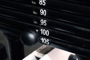 Hundred kilos weight set on a training machine. Pull strength training equipment.