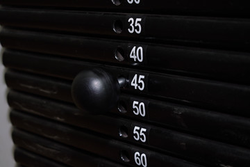 Forty-five kilos weight set on a training machine. Pull strength training equipment.