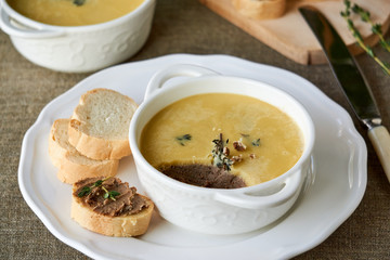 Chicken liver pate with thyme in a white bowl