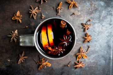 Mulled red wine in metal mug on the gray rustic background. Selective focus. Shallow depth of field.