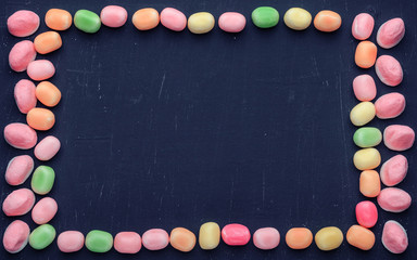 frame of multi-colored candies on a dark background with copy space - 307581682
