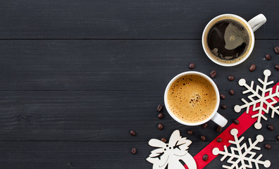 cup of hot coffee on black wooden on christmas holiday. top view