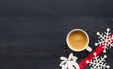 cup of hot coffee on black wooden on christmas holiday. top view