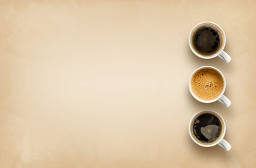 cups of coffee on brown paper background. top view