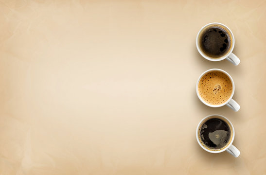 cups of coffee on brown paper background. top view