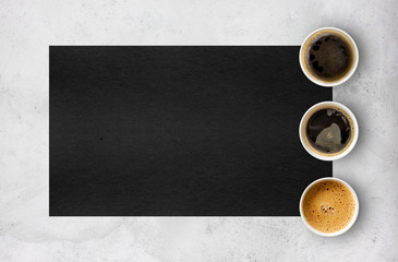 Obraz na płótnie Canvas paper cups of coffee on cement table background. top view