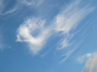 Blue sky with a white cloud running down