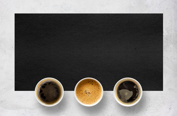 paper cups of coffee on cement table background. top view