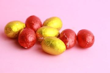 chocolate easter eggs, wrapped in yellow and red paper