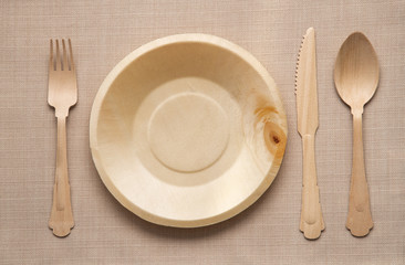 Wooden cutlery and empty clean plate