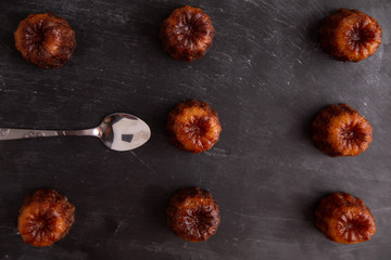 French pastry Caneles de bordeaux rum and vanilla flavor thick caramelized crust on black slate...