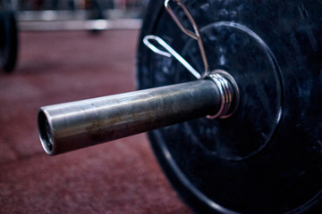 Side view of the barbel on the floor in the cross trainingbox. Concept of the crossfit training, online qualifiers for the cross training championships