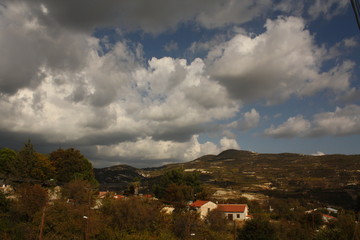 Fototapeta na wymiar Clouds and Troodos Mountains Viewed from the Village of Omodos, Cyprus