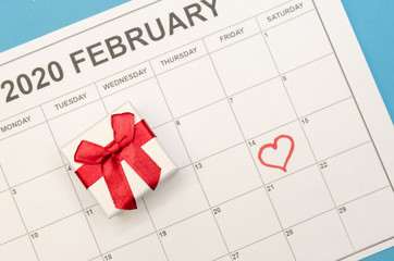 Valentine's day is marked with a heart on the calendar, there is a box with a ring next to it. Concept of Valentine's day, holiday