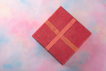 Gift box on a colored table