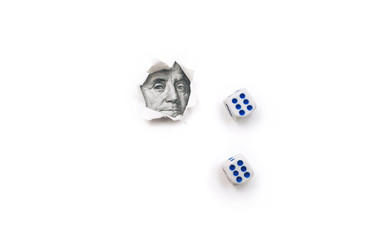 Franklin portrait in a torn hole of white paper and two dice 6. The concept of gambling, casino, losing and luck. Win or lose. Copy space.