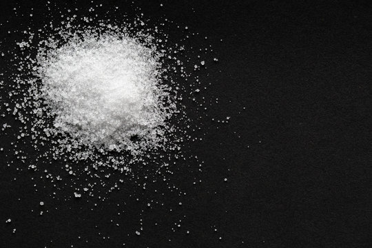 pile of sea salt on black background