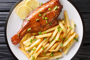 Healthy food fried red perch fish with French fries close-up in a plate. horizontal top view
