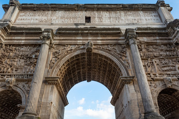 Arch of Septimius Severus at the northwest end of the Roman Forum. White marble triumphal arch