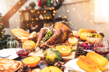 Naklejka na ściany i meble Roasted chicken or turkey with sauce and grilled autumn vegetables: corn,pumpkin on wooden table, top view, frame. Christmas or Thanksgiving Day food concept.