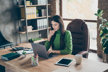 Profile photo of pretty young business lady looking seriously screen notebook on table modern user...