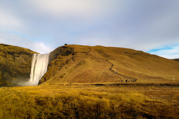 Beautiful scenery of mountain with Skogafoss waterfall in Iceland.