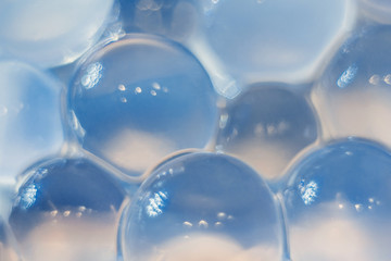 Abstract texture, blue crystalline balls of hydrogel for the background. Hydrogel beads. Close up and out of focus. - obrazy, fototapety, plakaty