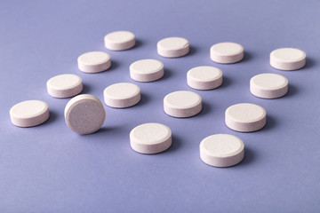 Obraz na płótnie Canvas Vitamin Pills. Pattern of pills on colored background. Herbal circle pills
