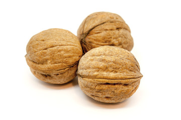 Three walnuts closeup on a white background. Isolated