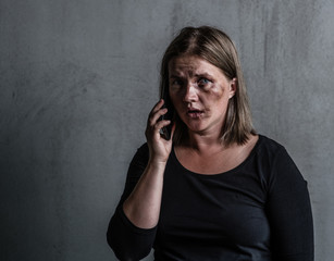 Woman victim of domestic violence and abuse asks for help by phone. Empty space for text