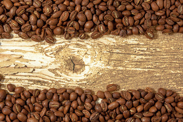 The flat layout of coffee beans in the top and bottom of the old wooden boards. Frame of grains.