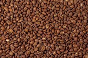 Background from tightly poured coffee beans. View from above.