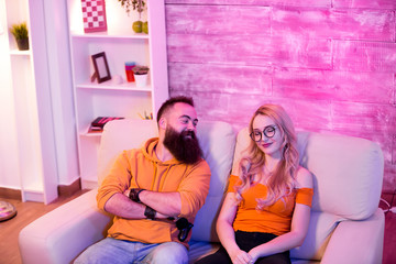 Naklejka premium Boyfriend looking at his girlfriend after winning aginst her