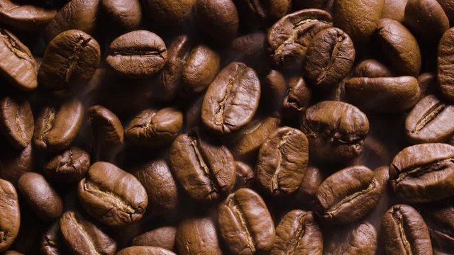 Close up coffee beans are roasted and rotated clockwise. Blackmagic 6K Camera.