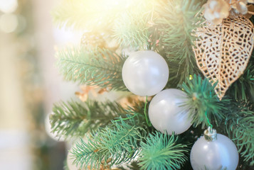 Fototapeta na wymiar Blurry of Christmas and New Year's balls with beautiful decorations on the Christmas tree, soft light, beautiful background images and illustrations.