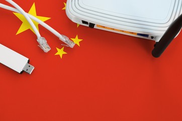 China flag depicted on table with internet rj45 cable, wireless usb wifi adapter and router....