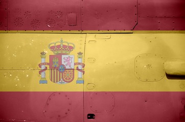 Spain flag depicted on side part of military armored helicopter closeup. Army forces aircraft...