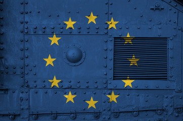 European union flag depicted on side part of military armored tank closeup. Army forces conceptual...