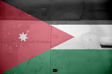 Jordan flag depicted on side part of military armored helicopter closeup. Army forces aircraft...