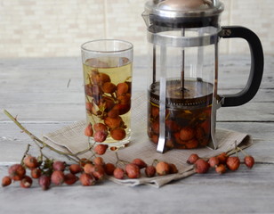 Winter. Vitamin products. On the table there is a teapot for tea, a glass with a healing rosehip drink.