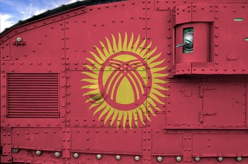 Kyrgyzstan flag depicted on side part of military armored tank closeup. Army forces conceptual...