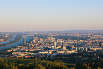 Vienna, Austria - 21 September 2019: Beautiful view of the evening skyline of Vienna and Danube River with green trees of Doebling district, Austria. Travel photo of the landmark